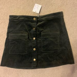 Corduroy olive green skirt with buttons for sale. Tags on. Never worn, tags on.